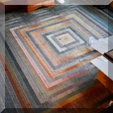 D20.  Multicolored rug. 7'9” x 7'9” 